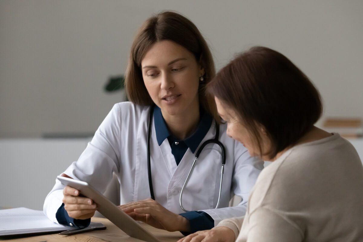 Woman doctor and patient on a tablet