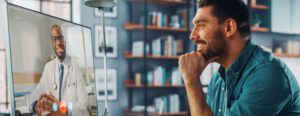 Man looking at a doctor on desktop screen