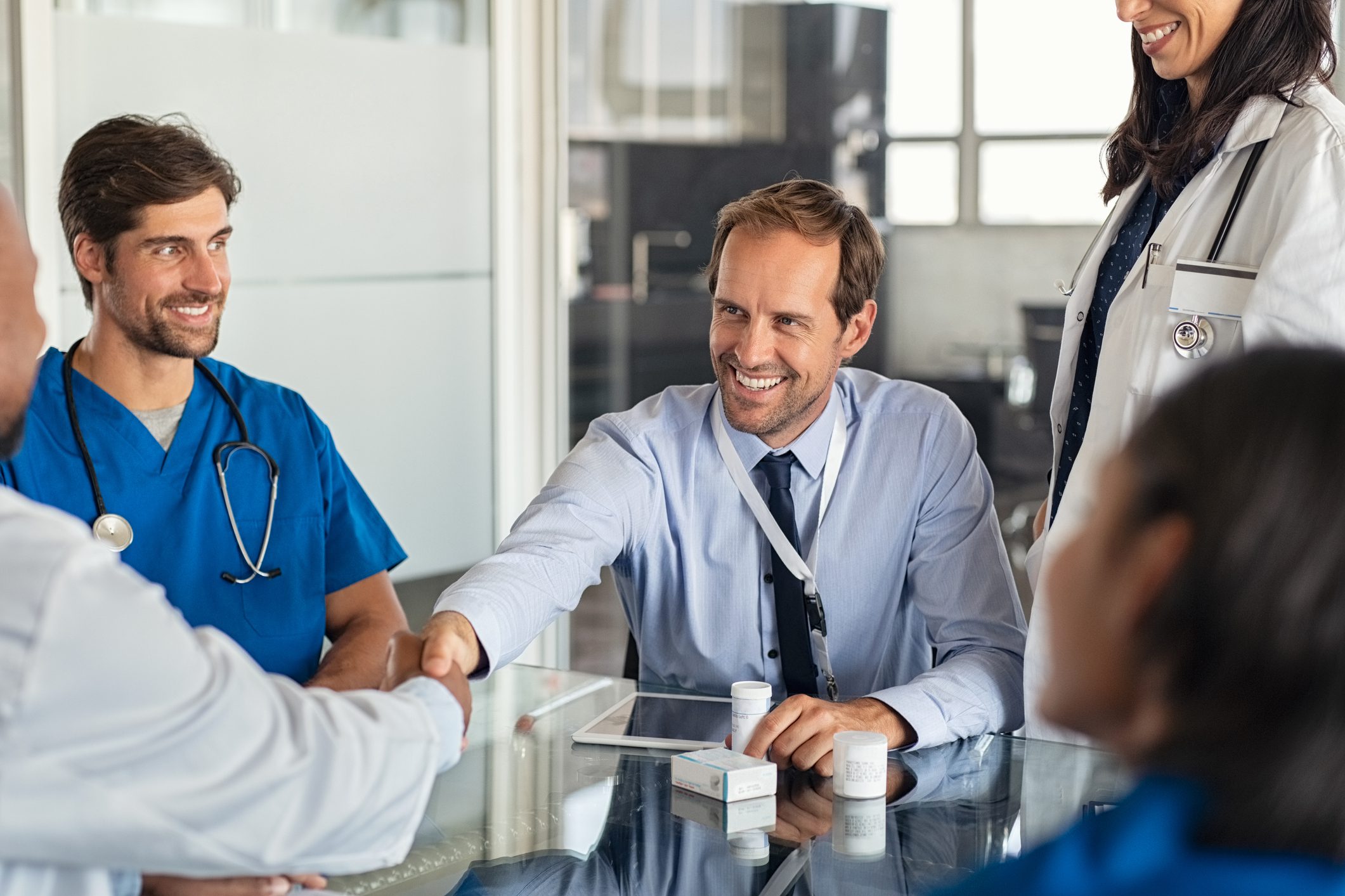 Corporate Medicine - Salesman shaking hands with doctor